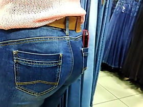 Round ass saleswoman in tight jeans